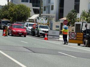 Traffic control Gold Coast — Get Directed managing coastal road lane closure with stop/slow bat.