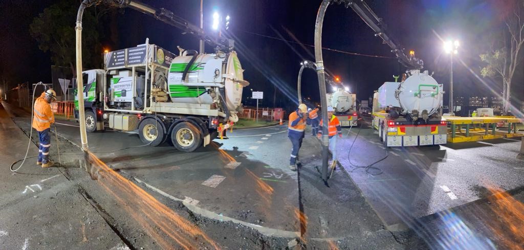 Vacuum excavation crew working at night