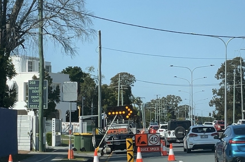 Traffic passing through a temporary traffic control setup on the Gold Coast